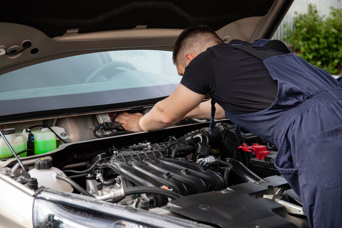 Mechanic servicing a car engine